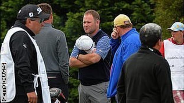 Alastair Forsyth talks to fellow golfers after the heart attack of his caddie Iain McGregor