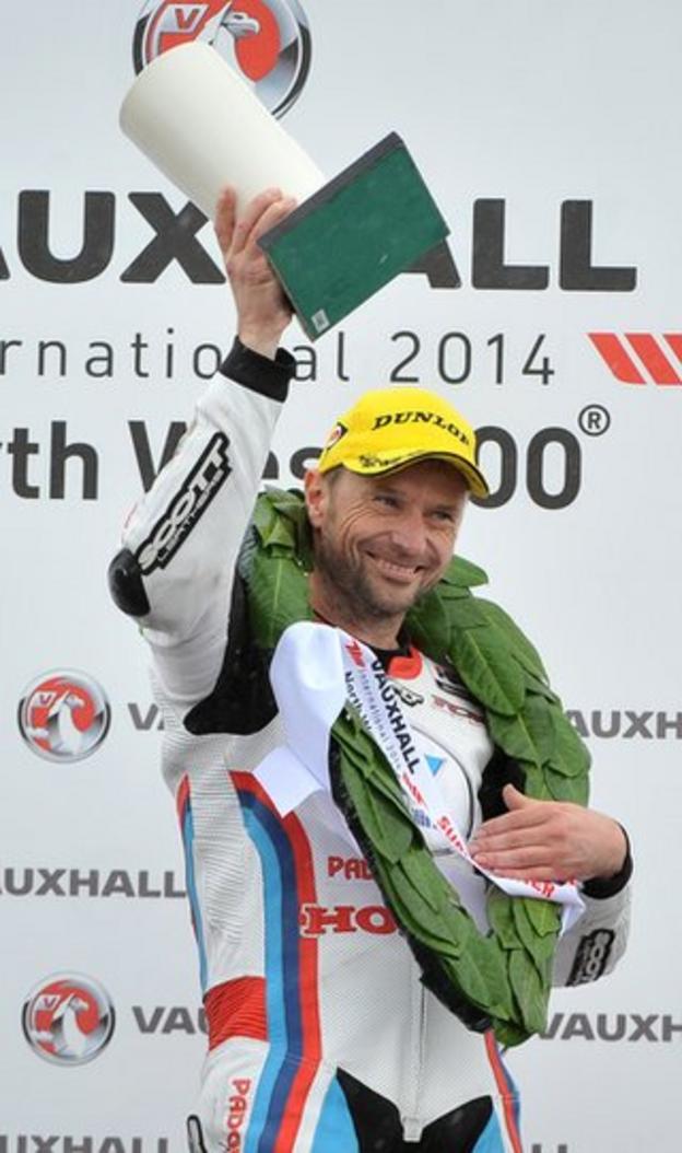 A delighted Bruce Anstey celebrates winning the Supersport race after leaders Lee Johnston and Alastair Seeley crashed out on the final lap