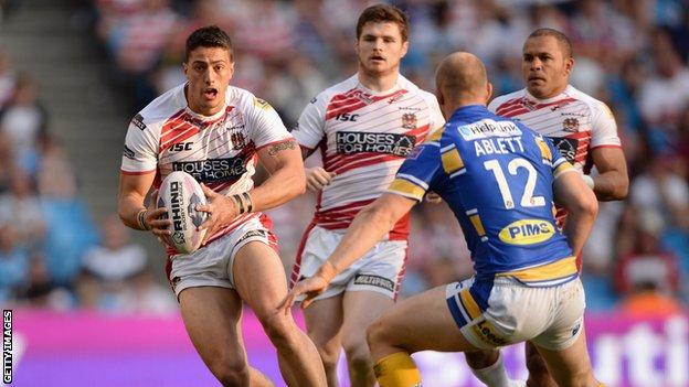 Wigan's Anthony Gelling looks to get past Carl Ablett of Leeds