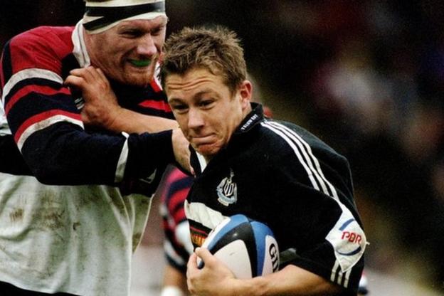 Jonny Wilkinson playing for the Newcastle Falcons holds off a challenge from West Hartlepool's Philippe Farner