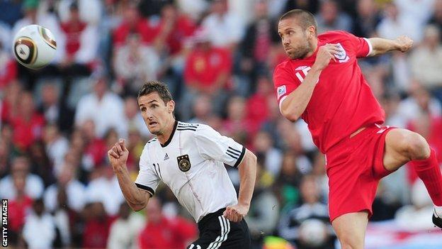 Matthew Upson wins a header playing for England against Germany in the 2010 World Cup