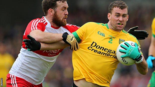Donegal's Eamon McGee is tackled by Derry's Emmet McGuckin at Celtic Park