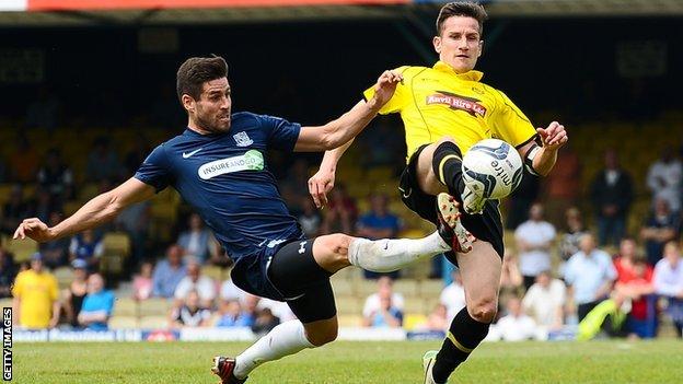 Lee Bell (right) is challenged by Southend's Michael Timlin during the League Two play-off semi-final at Roots Hall