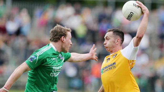 Fermanagh defender Aidan Breen closes in on Brian Neeson, who impressed with 1-6 for the Saffrons
