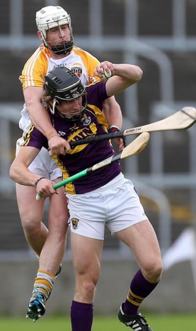 Antrim's Aaron Graffin gets a firm grip on Liam Og McGovern in the Leinster SHC quarter-final against Wexford in Portlaoise