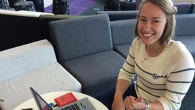 Lizzy Yarnold gives a thumbs up as she sits by her laptop after answering quesions on twitter
