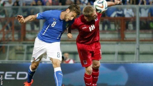 Italy's Claudio Marchisio (left) heads the ball to score against Luxembourg