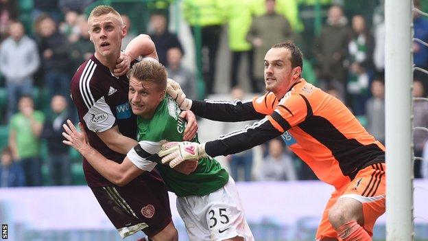 Hearts and Hibs players tussle inside the penalty box