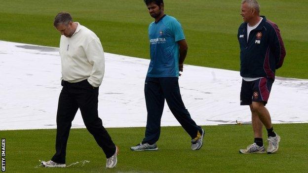 Umpires inspect the pitch at Wantage Road