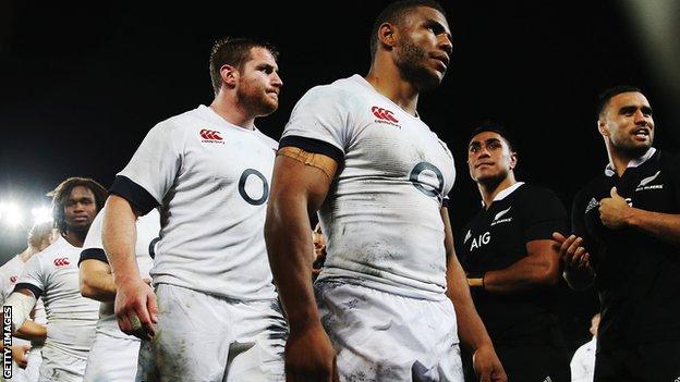 England's Ben Morgan and Kyle Eastmond look dejected as New Zealand's Liam Messam enjoys the victory