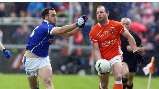 Eugene Keating closes in on Ciaran McKeever as Armagh defeat Cavan in the last eight tie at the Athletic Grounds
