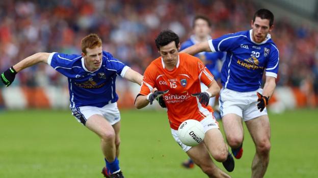 Cavan players Jason McLaughlin and Killian Brady in hot pursuit of Armagh forward Jamie Clarke