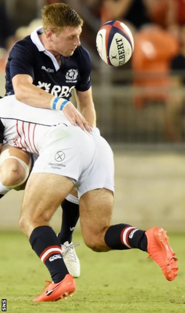Scotland's Finn Russell (left) is tackled by Seamus Kelly