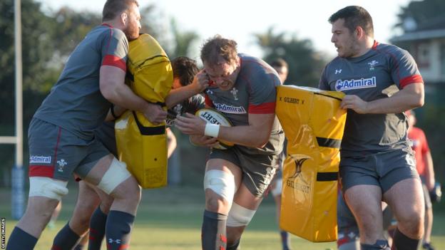 Wales captain Alun Wyn Jones drives through crash pads during a Welsh training session in South Africa.
