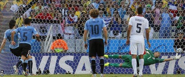 Edinson Cavani (left) puts Uruguay in front against Costa Rica with a clinical penalty