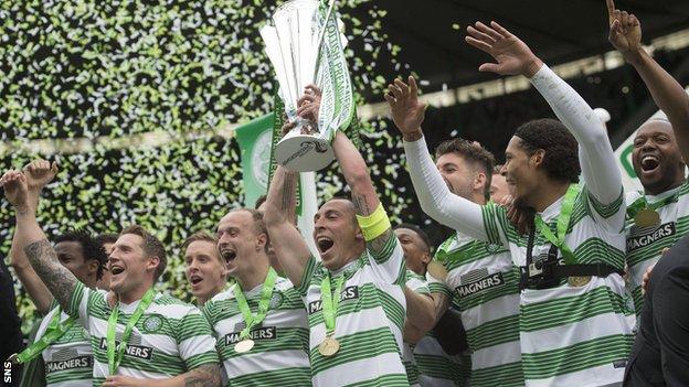 Celtic players celebrating with the Scottish Premiership trophy