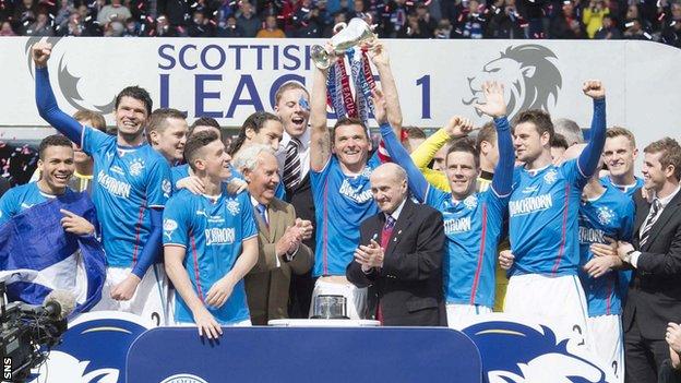 Rangers players celebrate with the Scottish League One trophy