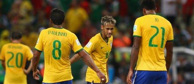 Brazil players Neymar (centre),, Paulinho (left) and Jo react at the final whistle after being held to a goalless draw