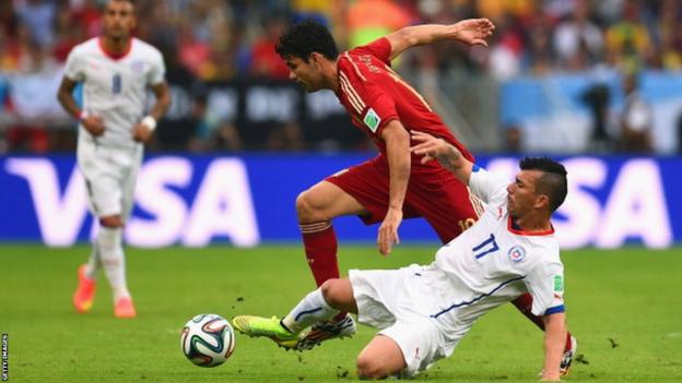 Cardiff City's Gary Medel of Chile tackles Spain's Diego Costa during the World Cup Group B match at the Maracana Stadium in Rio, Brazil.