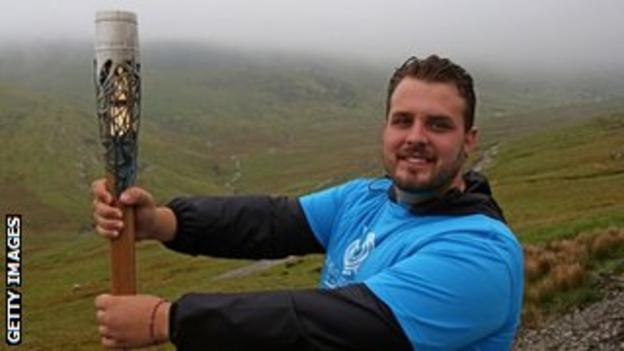Aled Sion Davies with the Queen's Baton on Snowdon