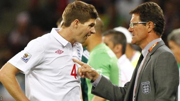 Fabio Capello talks with England team captain Steven Gerrard during the Fifa World Cup 2010 group C preliminary round match between England and Algeria