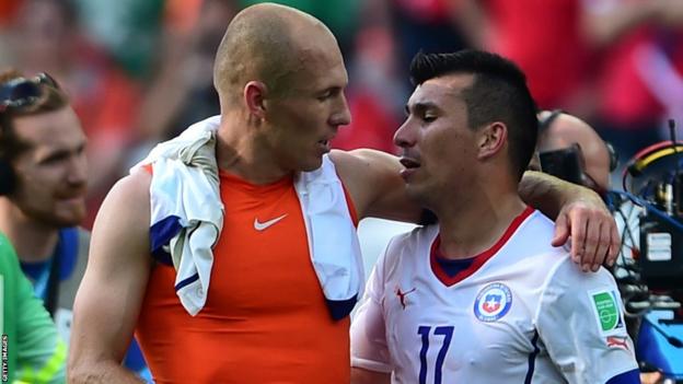 Forward Arjen Robben (left) speaks to Cardiff City's Gary Medel after the Netherlands' 2-0 victory against Chile to top Group B at the World Cup in Brazil