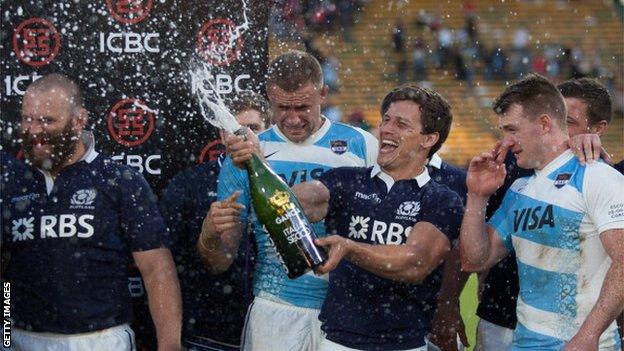 Scotland's scrum-half Grayson Hart (2R) spray champagne after the victory over Argentina in Cordoba
