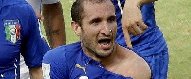 Italy defender Giorgio Chiellini appearing to claim Uruguay striker Luis Suarez bit him
