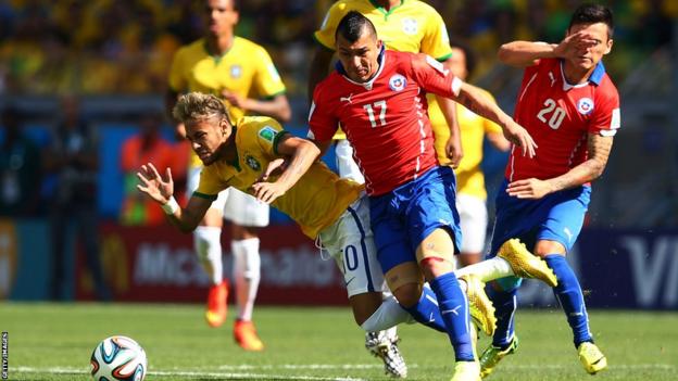Cardiff City's Gary Medel challenges Brazil's Neymar for the ball during Chile's last 16 clash against the World Cup hosts