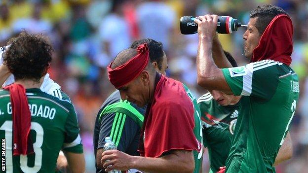 Mexico defender Francisco Rodriguez (right) waters his face