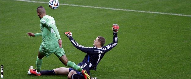 Germany's goalkeeper Manuel Neuer challenges Algeria's Islam Slimani