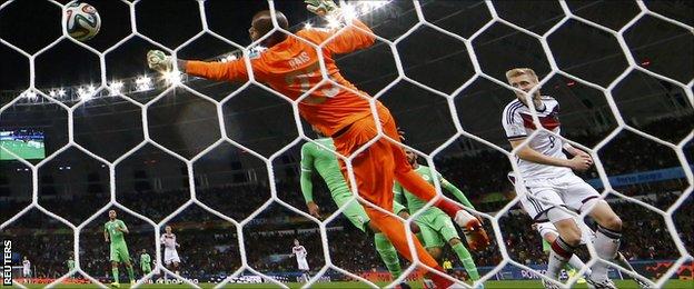 Germany's Andre Schurrle scores past Algeria's goalkeeper