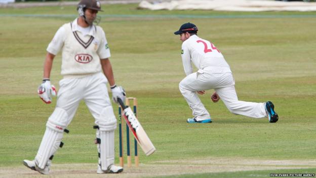Surrey’s Vikram Solanki is caught by Chris Cooke of Glamorgan in the County Championship game at Colwyn Bay.