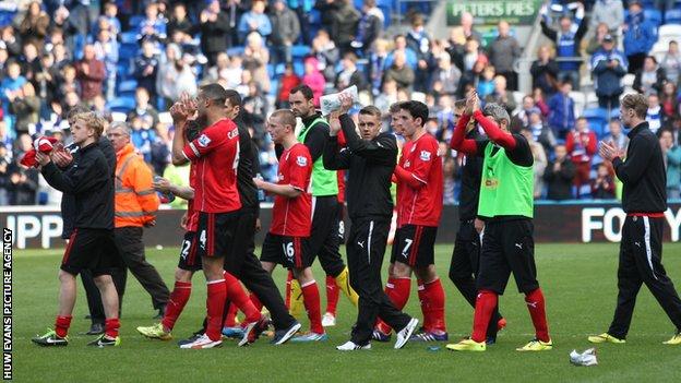 Cardiff manager Ole Gunnar Solskjaer leads the players around the pitch to applaud the fans at the end of the last game of the 2013/14 season