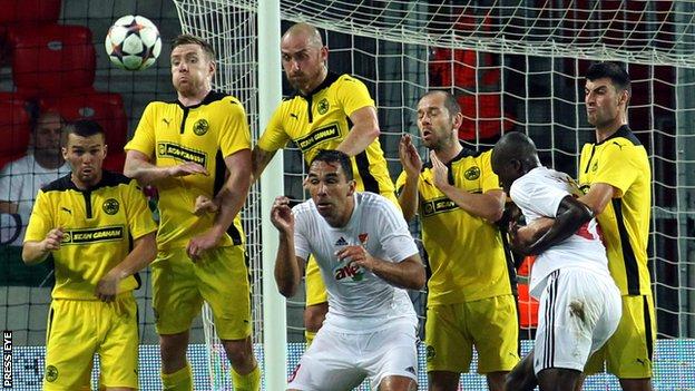 Cliftonville pair Chris Curran and Barry Johnston rise highest to keep out a free-kick in Hungary