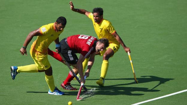 Owain Dolan-Gray is tackled during Wales' 3-1 defeat to India in the men's hockey at the Commonwealth Games.