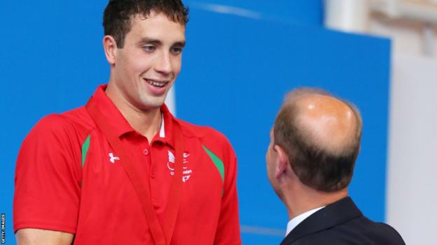 Calum Jarvis is presented with his 200m men's freestyle bronze medal - Wales' first of the Games in the swimming pool - by the Earl of Wessex.