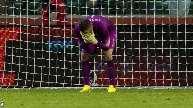 Celtic keeper Fraser Forster stands dejected as Leiga Warsaw score their fourth goal of the game.