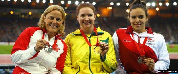 Silver medallist Diane Roy of Canada, gold medallist Angela Ballard of Australia and bronze medallist Jade Jones of England pose on the podium during the medal ceremony for the Womens Para-Sport 1500 metres T54