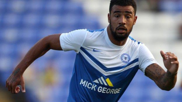 Peterborough see off League One newcomers Rochdale to make a winning start to the campaign thanks to Kyle Vassell's second-half goal.