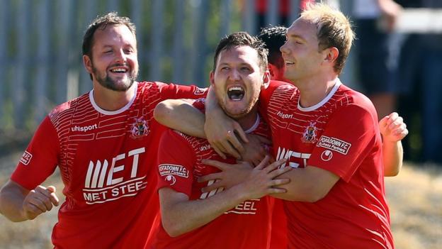 Tim Mouncey and Ross Redman celebrate with striker Gary Twigg who scored two of Portadown's goals in their 3-0 win over Linfield
