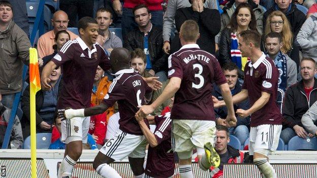 The Hearts players celebrate with goal scorer Osman Sow as his late goal earns the visitors victory over Rangers.