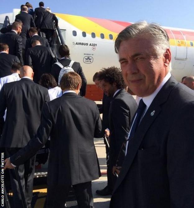 Carlo Ancelotti prepares to board a plane with his Real Madrid team as they head to Cardiff airport.