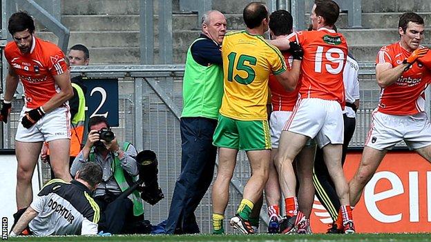 Donegal's team doctor Kevin Moran falls to the ground at Croke Park