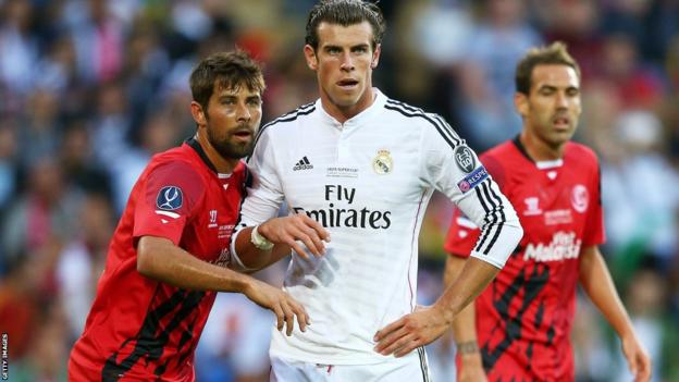 Sevilla defender Coke discovers the Real thing, keeping a close eye on Gareth Bale.