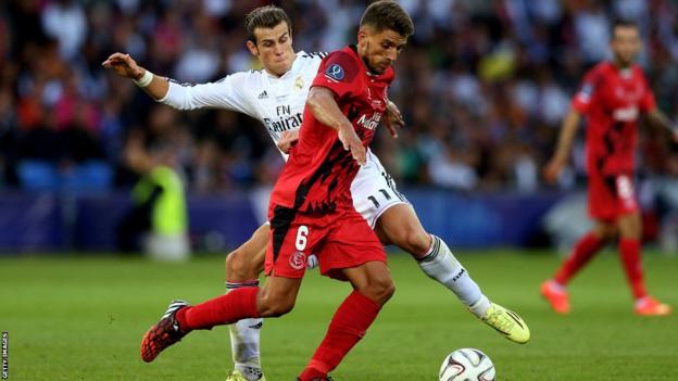 Bale tackles Sevilla's Daniel Carrico.