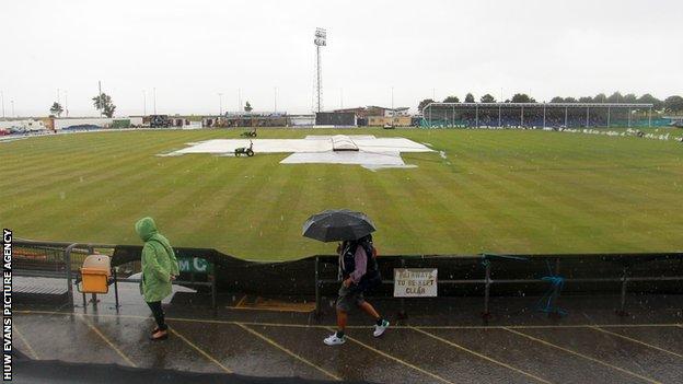 Spectators faced a bleak scene when heavy rain fell during the middle of the match