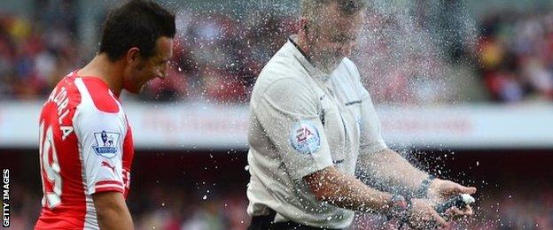 Referee Jonathan Moss accidentally sprayed vanishing foam over himself and Santi Cazorla