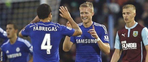 Cesc Fabregas celebrates Chelsea's second goal against Burnley with scorer Andre Schurrle