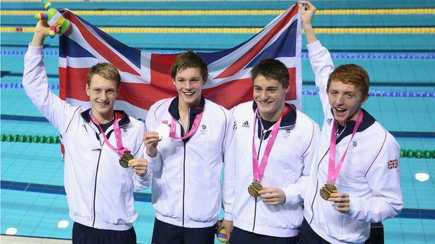 Team GB's 4x100m freestyle medley team pose with their gold medals.